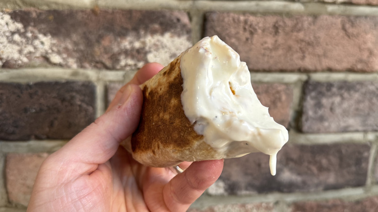 a Quesarito dipped in Creamy Garlic Sauce