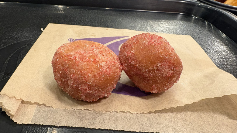 Two Strawberry Cinnabon Delights sitting upon their wrapper
