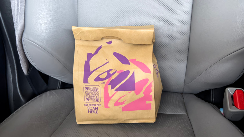A Taco Bell bag on a car seat
