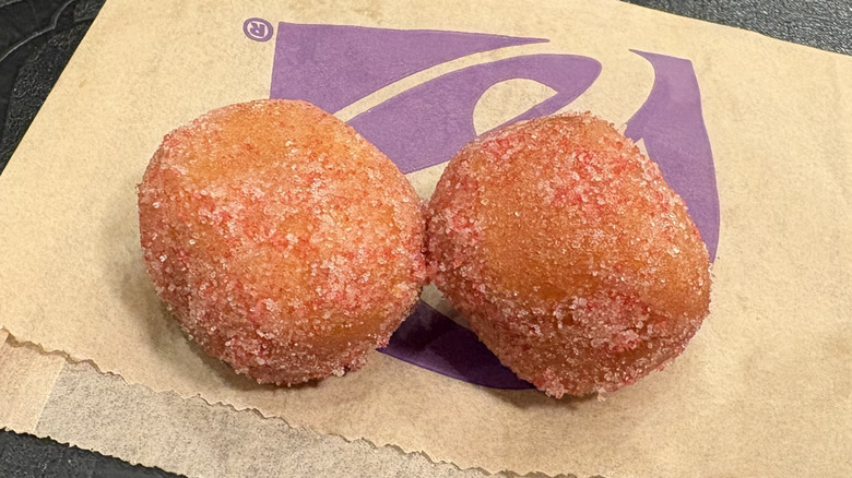 Two Strawberry Cinnabon Delights sitting on their wrapper