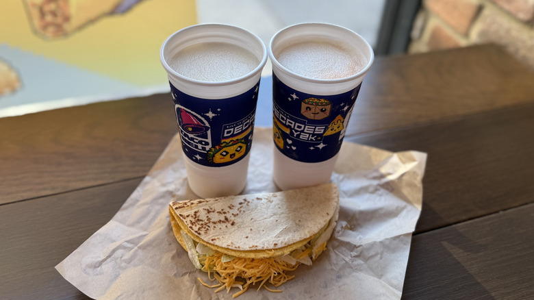 Taco Bell's Vanilla Cream Soda and Orange Vanilla Cream Soda Freezes behind a taco