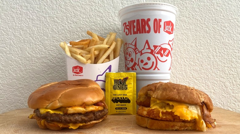 Both sandwiches accompanied by fries, a drink, and the Hot Ones The Last Dab: Apollo hot sauce packet