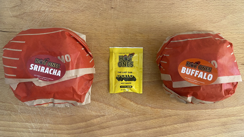 Overhead view of both wrapped sandwiches and the Last Dab: Apollo hot sauce packet