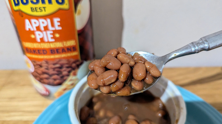 Bush's Baked apple pie beans on a spoon with the can in the background