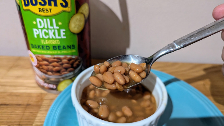 Dill Pickle baked beans on a spoon with the can in the background