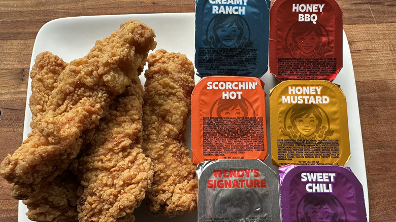 Wendy's chicken tenders on a plate with sauces