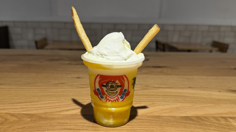 two fries stick out of a Wendy's x Minions Banana Frosty Swirl