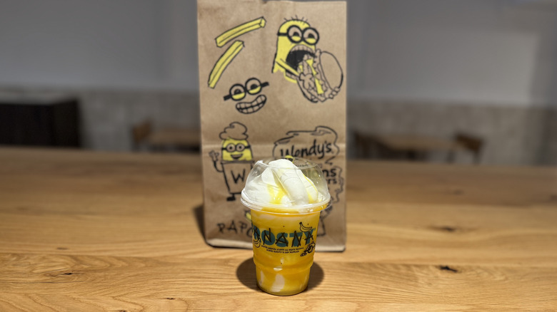 Wendy's x Minions Banana Frosty Swirl in front of a Minions-styled bag