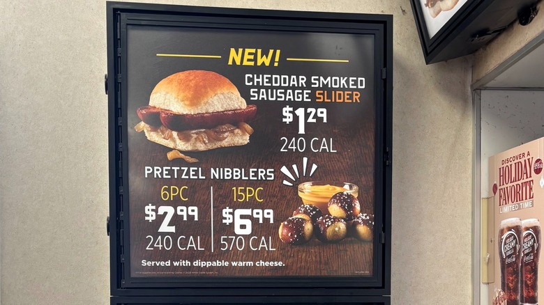 White Castle menu signage of new Cheddar Smoked Sausage Slider and Pretzel Nibblers with prices and calories.