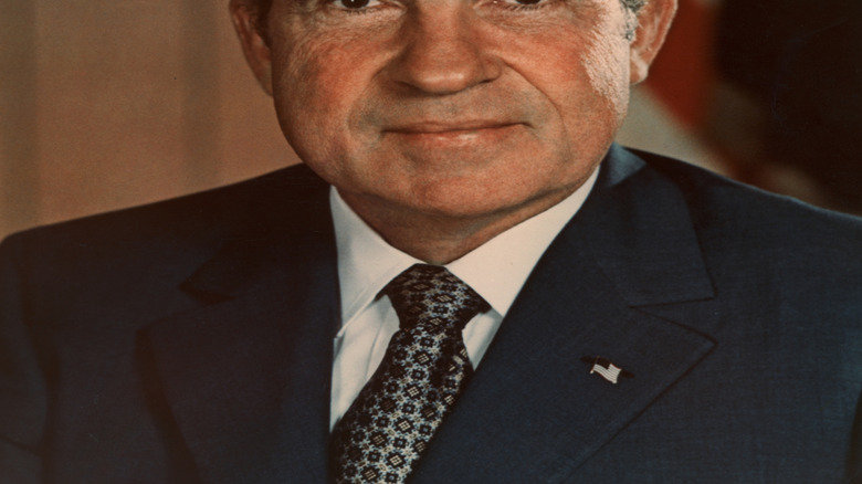 Richard Nixon in front of an American flag