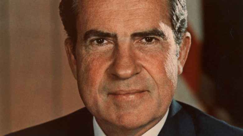 Richard Nixon in front of an American flag