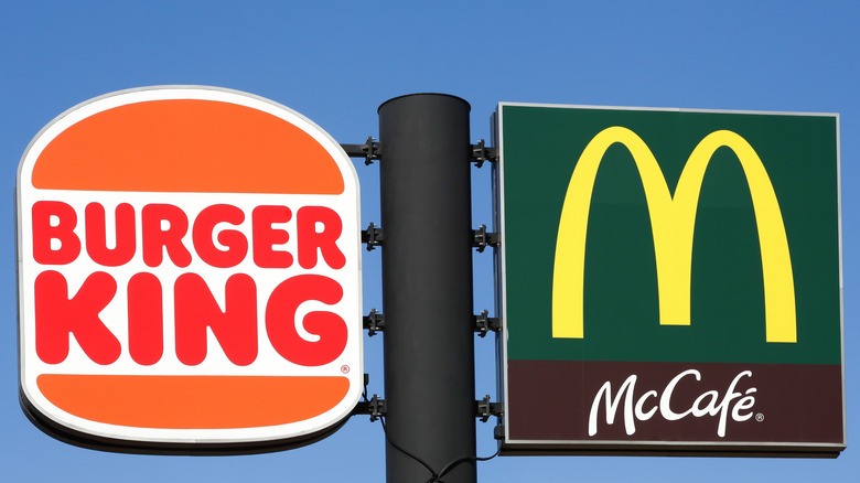 A Burger King sign next to a McDonald's sign.