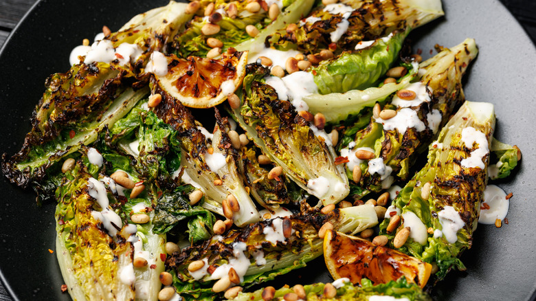 grilled romaine lettuce with creamy sauce and toasted pine nuts