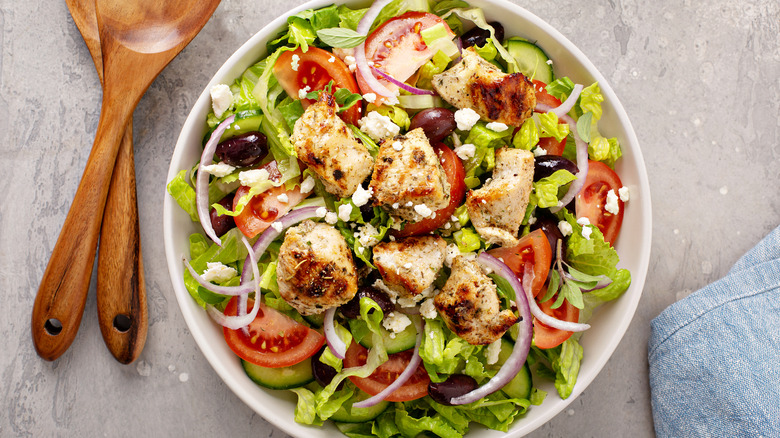 A plate of cucumber chopped salad with fork
