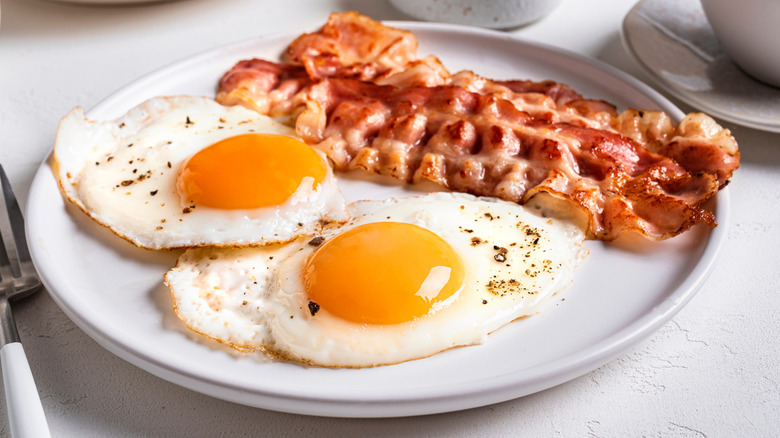 Breakfast plate withe crispy bacon and sunny side up eggs