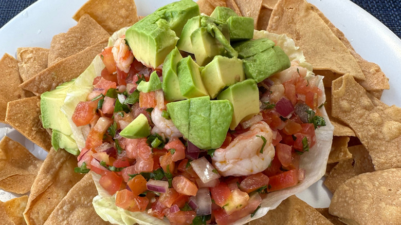 Shrimp ceviche layered over a bed of tortilla chips