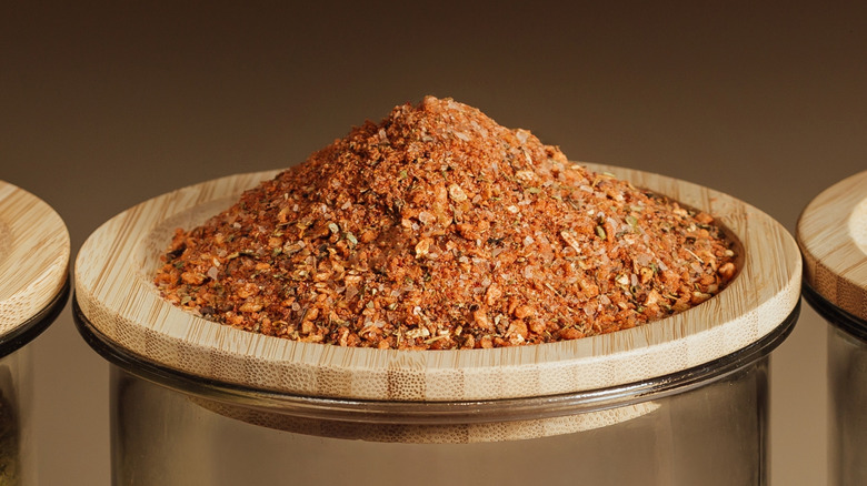 Seasoning mix on top of a glass container lid.