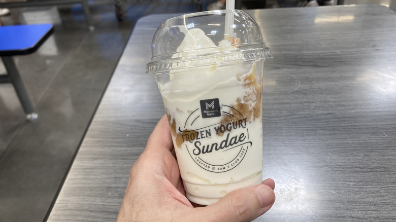 Hand holding Americana Sundae with spoon