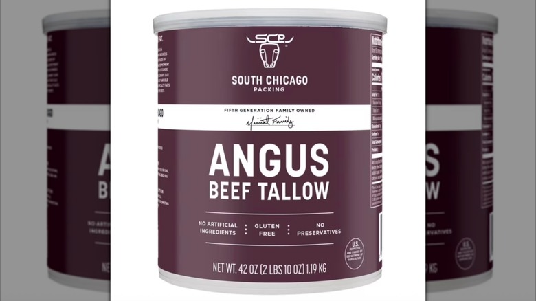 hands holding a beef bone over a can of South Chicago angus beef tallow