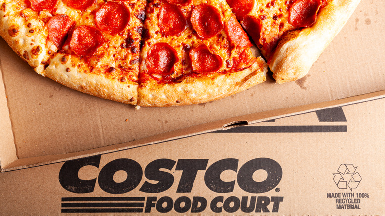 A Costco food court pizza sitting on top of a box.