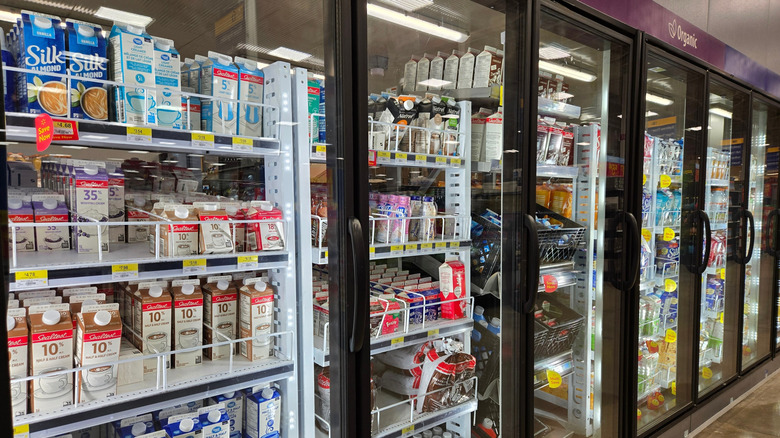 milk stored behind glass coolers in store