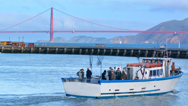 A fishing boat in the San Francisco Bay near Fisherman's Wharf with the Golden Gate Bridge in the background