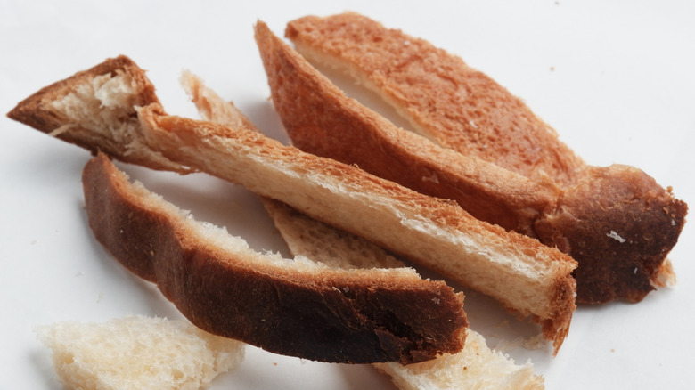 A close-up of brown bread crusts, cut from a slice of sandwich bread