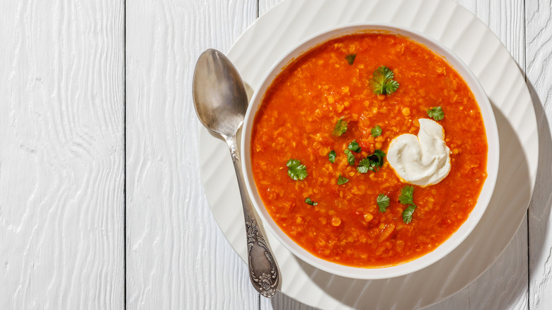 Red lentil soup topped with a dollop of sour cream