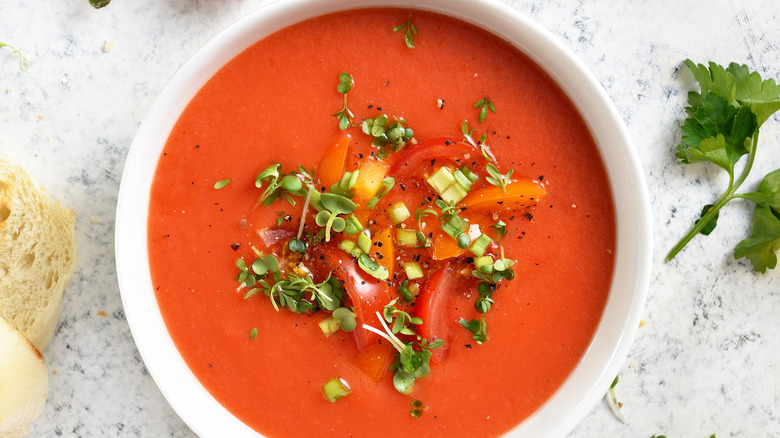 Fresh herbs atop a bowl of tomato soup