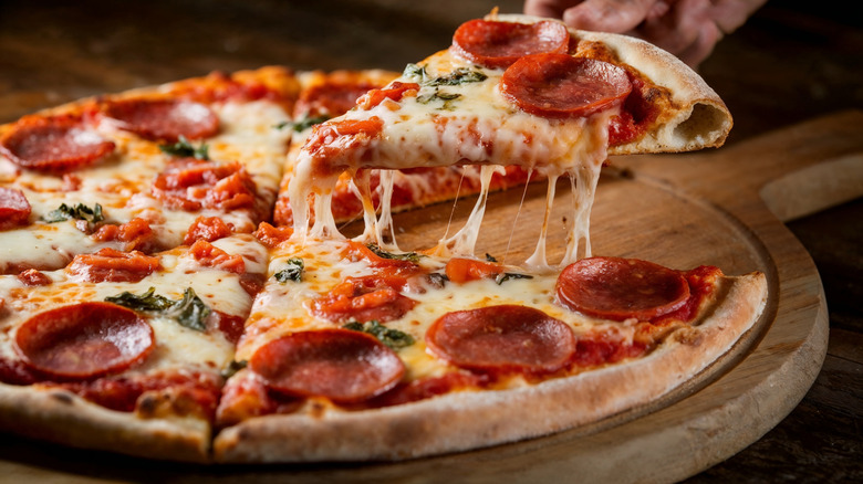 Pepperoni pizza on wooden board