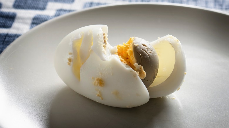 Overcooked boiled egg with gray yolk