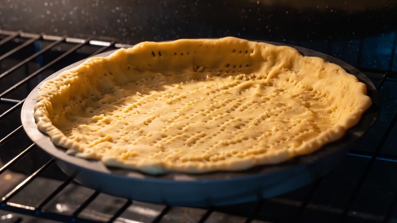 Pie crust baking in metal tin