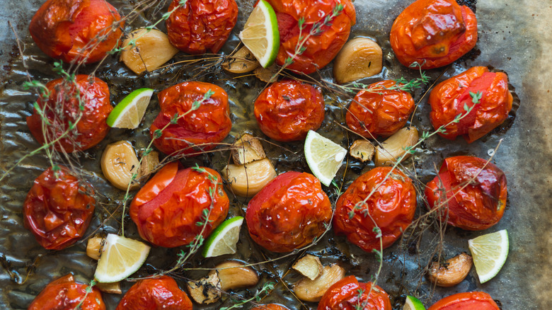 Roasted tomatoes on pan with garnish
