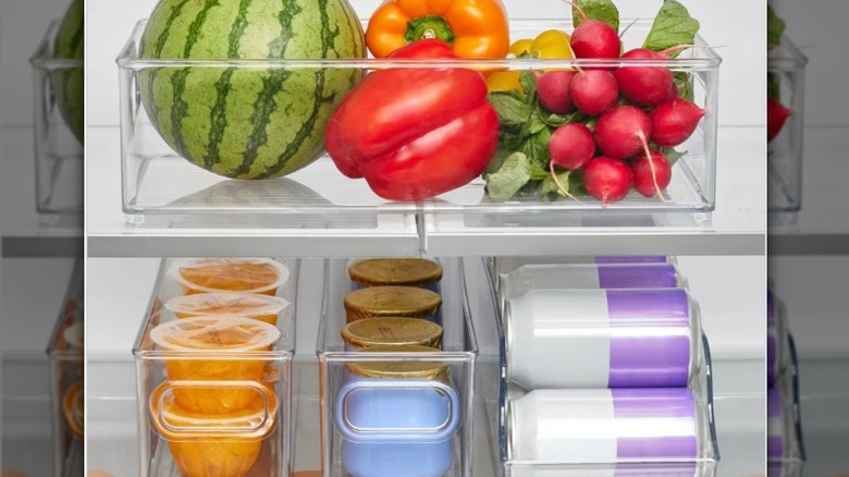 Costco's iDesign storage bins filled with vegetables, canned drinks, and fruit cups