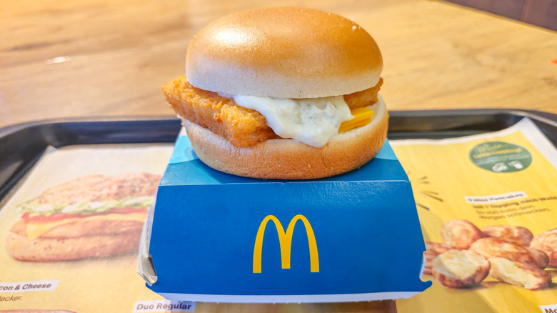 A McDonald's Filet-O-Fish sandwich on a blue takeout box