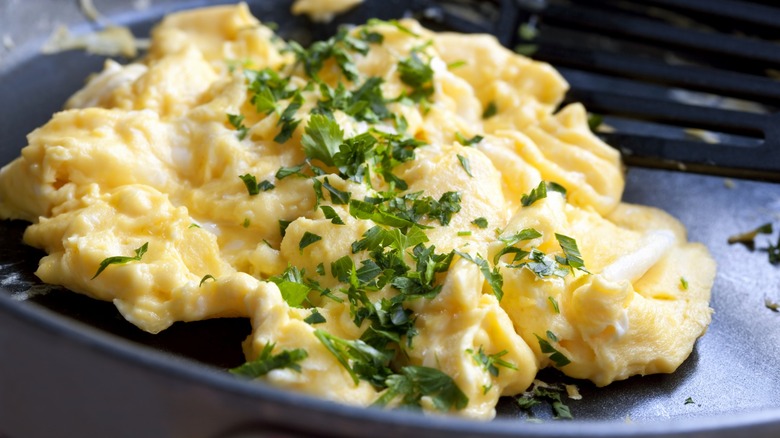 Scrambled eggs topped with parsley