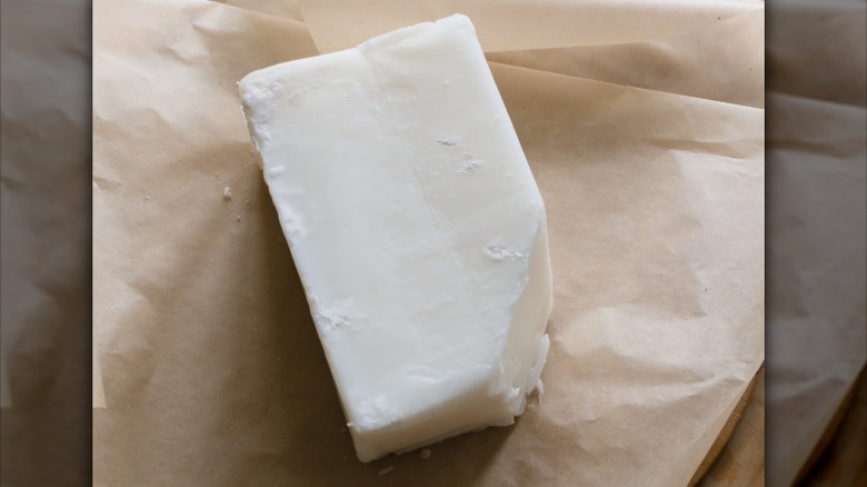 A block of beef tallow on parchment paper