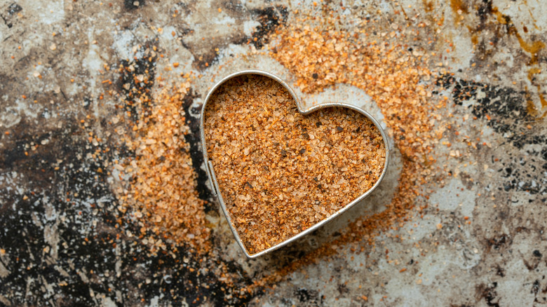 Cajun seasoning piled around a heart-shaped cookie cutter.