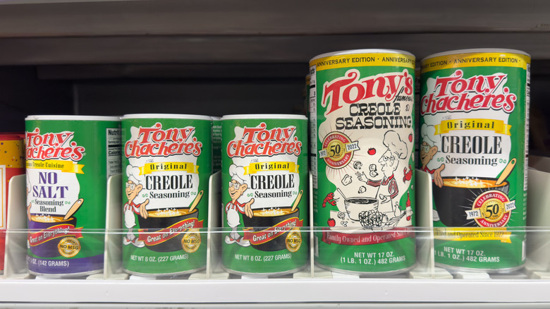 Containers of Tony Chachere's Original Creole Seasoning sitting on a shelf.