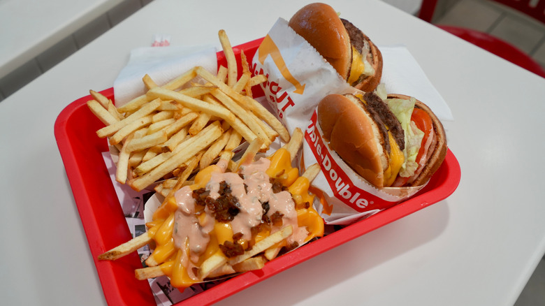 Two In-N-Out burgers with animal-style fries