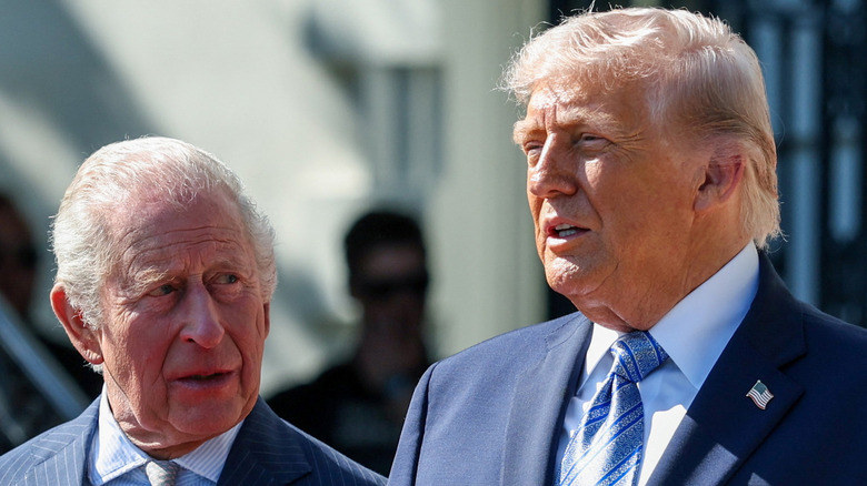 King Charles and Donald Trump standing in front of the White House.