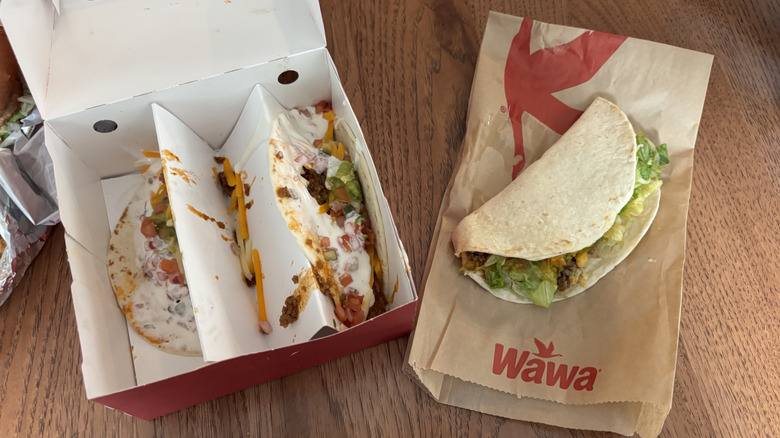 Sheetz street tacos on the left in takeout box; Wawa taco on top of bag on right