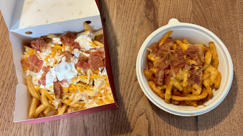 Takeout box of Sheetz loaded fries on the left; takeout bowl of Wawa's loaded fries on the right