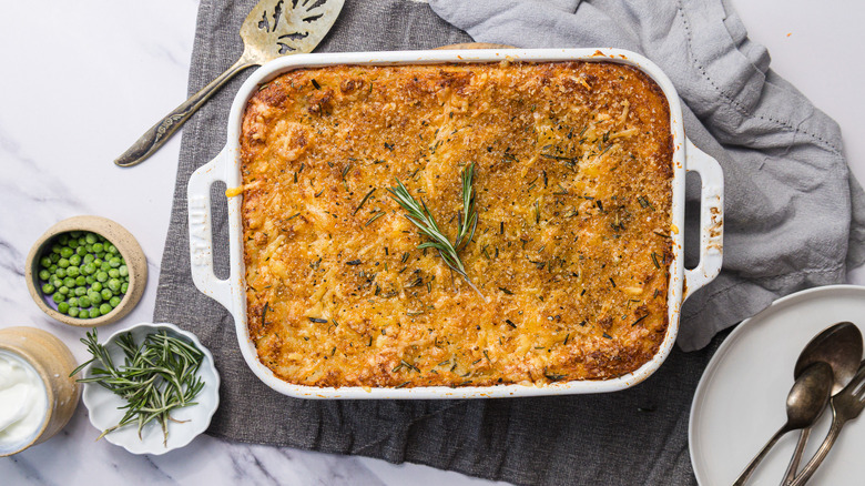 Shepherd's pie on table with napkins and serving utensils