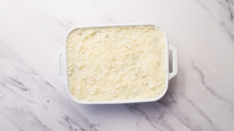 Casserole dish with shepherd's pie filling and topping