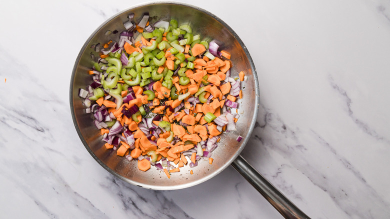 Veggies in hot pan with oil