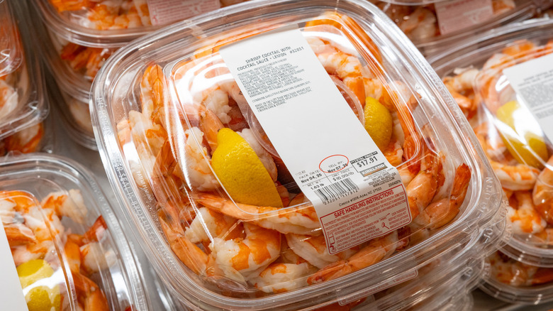 Costco cocktail shrimp platters in a refrigerated case in the store