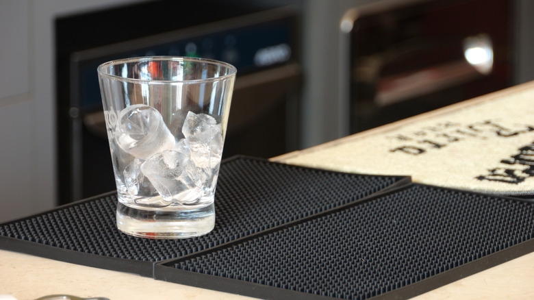 bar mat with empty glass on it