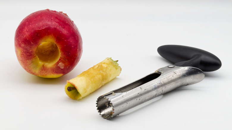 cored apple and apple core with apple coring tool