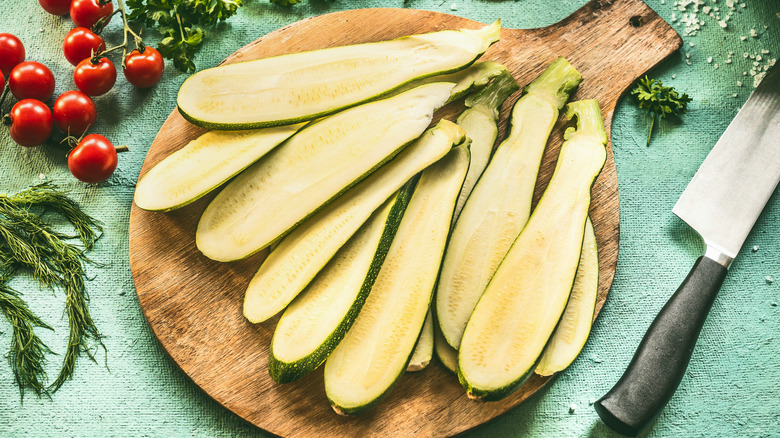 Sliced raw zucchini on a wooden board